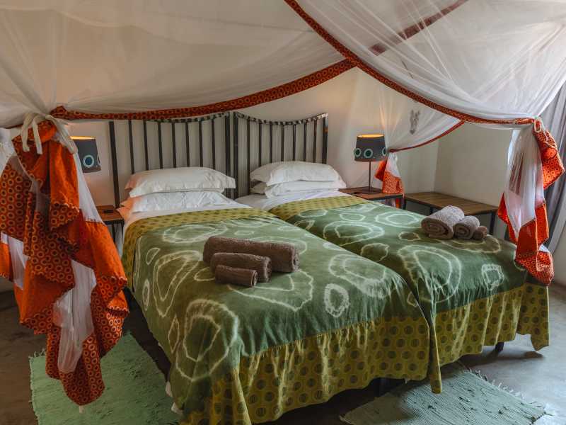 Rest in comfortable chalet accommodation at Boteti River Camp along the Boteti River