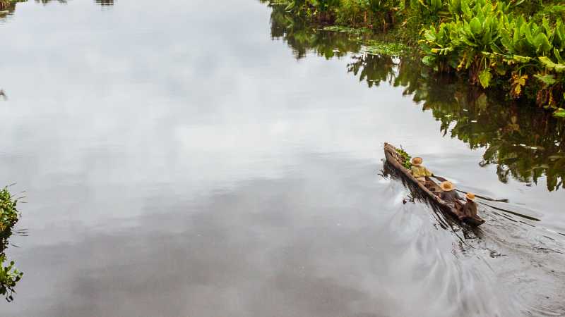 Traditional dugout canoes and villages line the tranquil waterways of the Pangalanes Canal