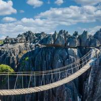 Walk across a suspension bridge to Tsingy de Bemaraha in Madagascar