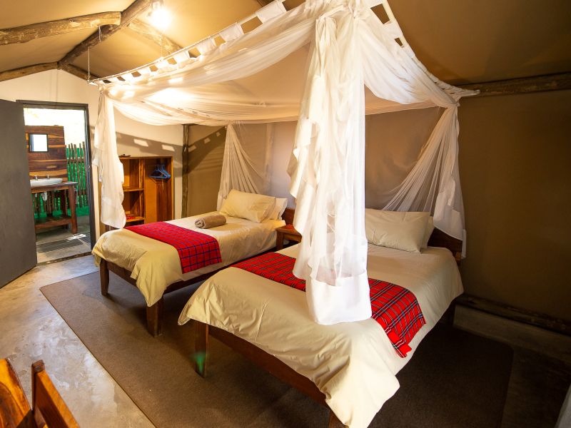 Katima Mutoya Lodge tented room with twin beds under mosquito netting