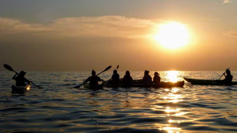 Kayak across the calm waters of Lake Kivu