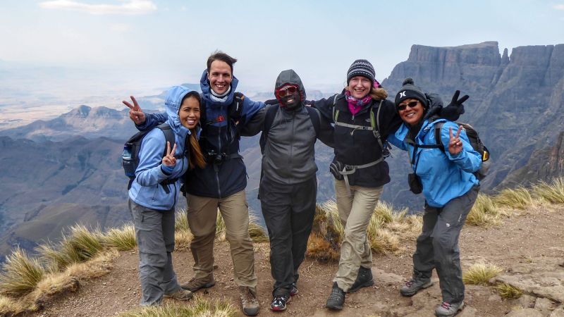 Happy group of hikers on top of the Amphitheatre in the Drakensberg Mountains - Drakensberg Walking Tour, South Africa