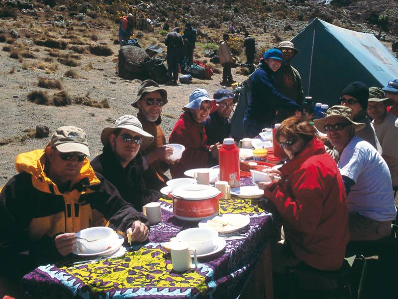 Camping beneath the snow capped peak of Kilimanjaro | Chris Buykx