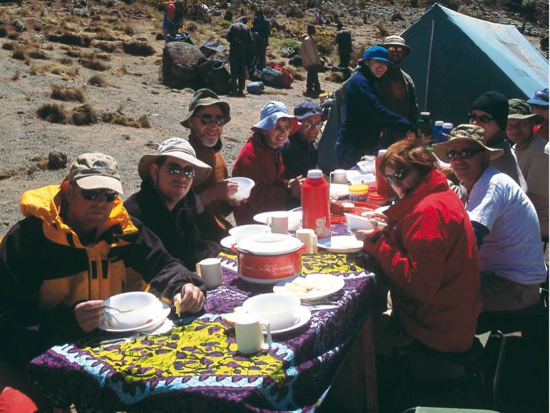 Camping beneath the snow capped peak of Kilimanjaro | Chris Buykx