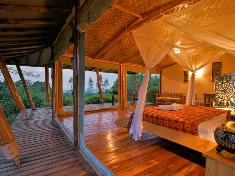 Queen Elizabeth: Marafiki Safari Lodge (or similar)
Perched above the plains of Queen Elizabeth National Park, this lodge offers an elevated stay within the surrounding savannah landscape. You stay in tented accommodation on raised timber platforms, with open sides and a private deck that connects you to the environment. The setting allows you to take in views across the park between game drives.