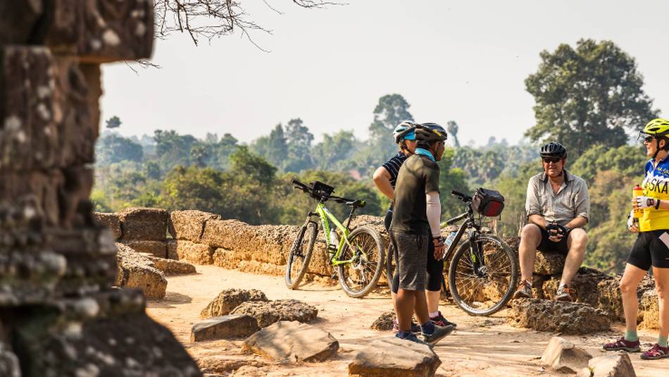 The local guide sharing stories during the exploration of the Angkorian ruins | Lachlan Gardiner