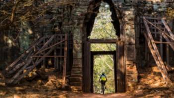 Riding through the quiet west gate of Angkor Thom
