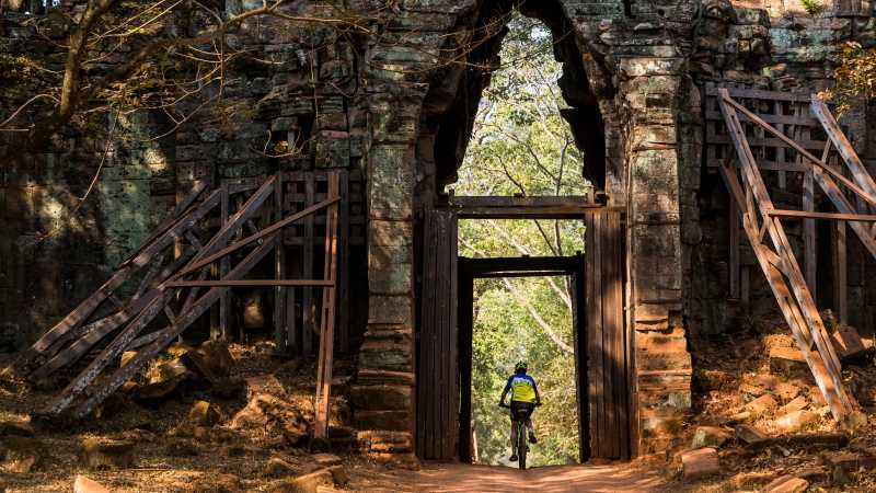 Riding through the quiet west gate of Angkor Thom | Lachlan Gardiner