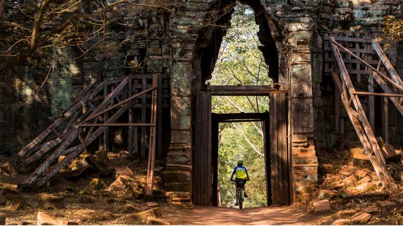 Riding through the quiet west gate of Angkor Thom | Lachlan Gardiner