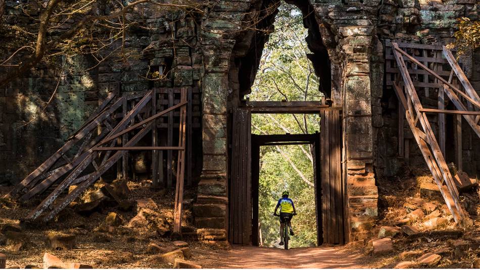Riding through the quiet west gate of Angkor Thom | Lachlan Gardiner