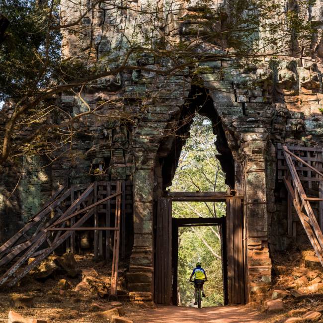 Riding through the quiet west gate of Angkor Thom | Lachlan Gardiner