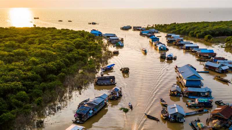 The sun setting over Mechrey floating village, Cambodia | Lachlan Gardiner