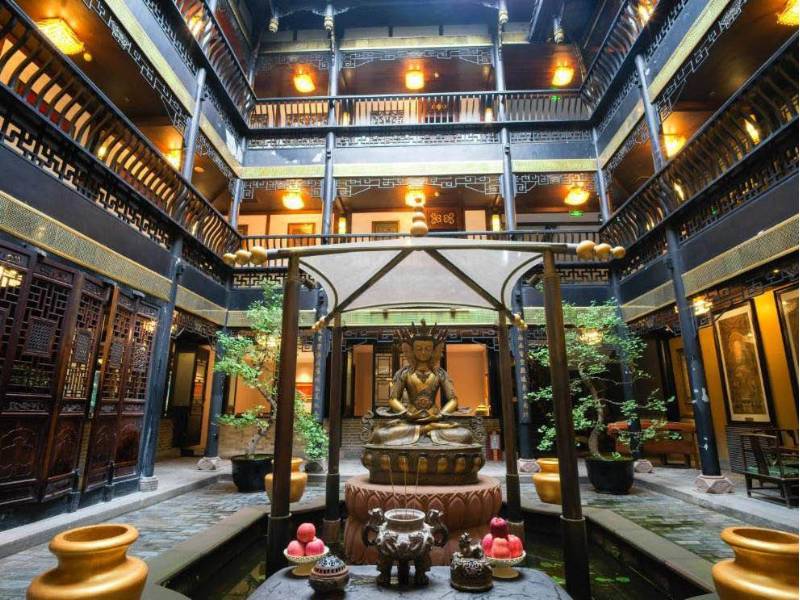 Interior of Buddha Zen Hotel, Chengdu: A serene space featuring traditional Chinese architecture, centred around a beautiful Buddha statue.
