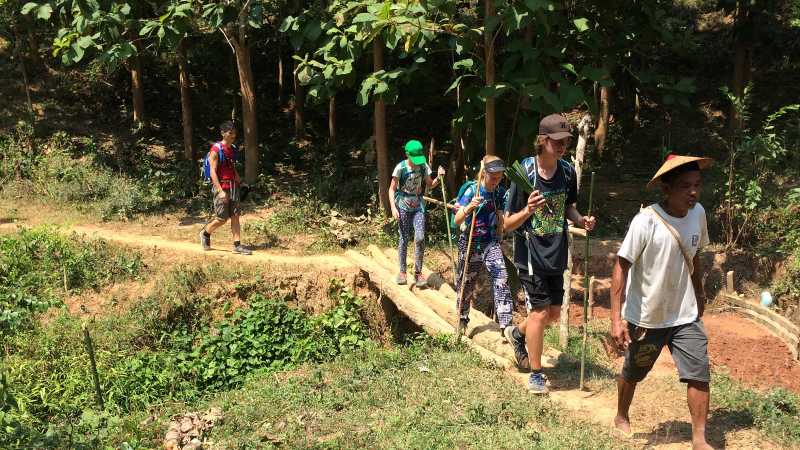 A family following our local hiking guide in Laos | Kate Harper
