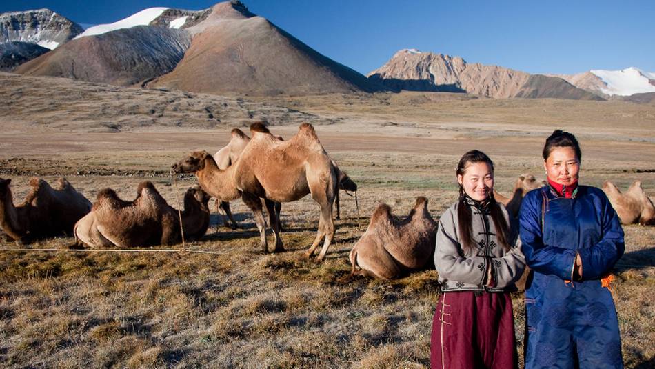 Local herders with their camels on the Mongolian steppe | Cam Cope