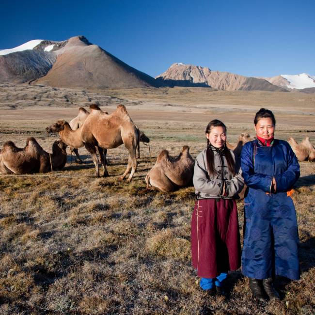 Local herders with their camels on the Mongolian steppe | Cam Cope