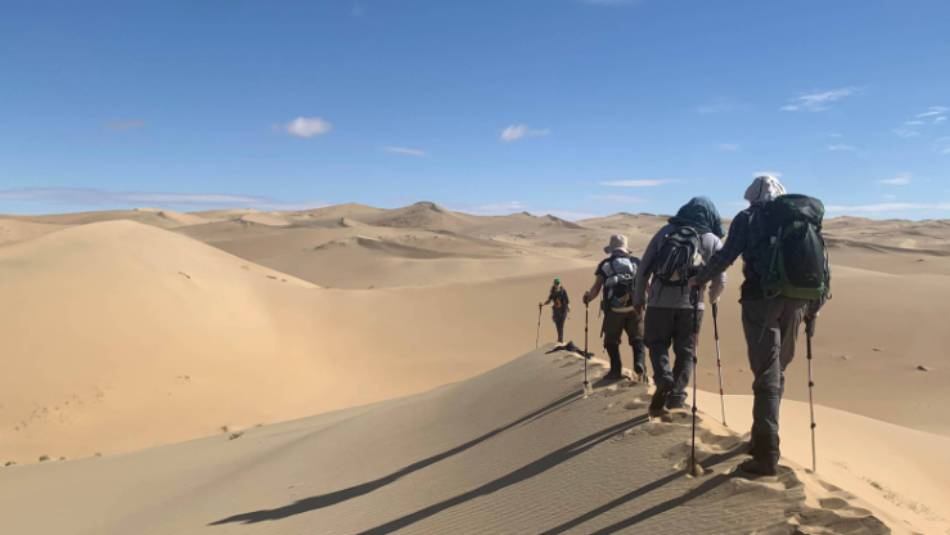Trekkers enjoy the sand dunes of Mongol Els, Mongolia | Tim Cope