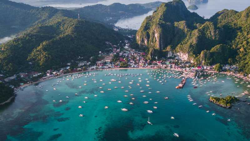 A sweeping aerial perspective of El Nido reveals its sheltered bay, emerald waters and surrounding limestone peaks. - A Culinary Expedition Through the Philippines with Chef Matthew Astorga, Philippines