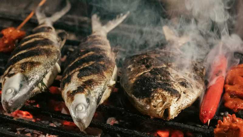 Caption: Fresh seafood cooked over hot coals showcases the rich and authentic culinary traditions of the Philippines. - A Culinary Expedition Through the Philippines with Chef Matthew Astorga, Philippines