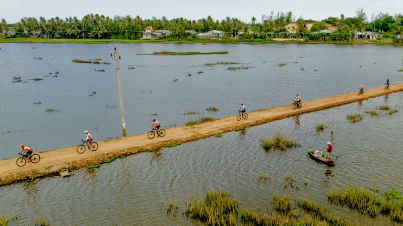 Cycling surrounded by rice paddies and village life in rural Vietnam
