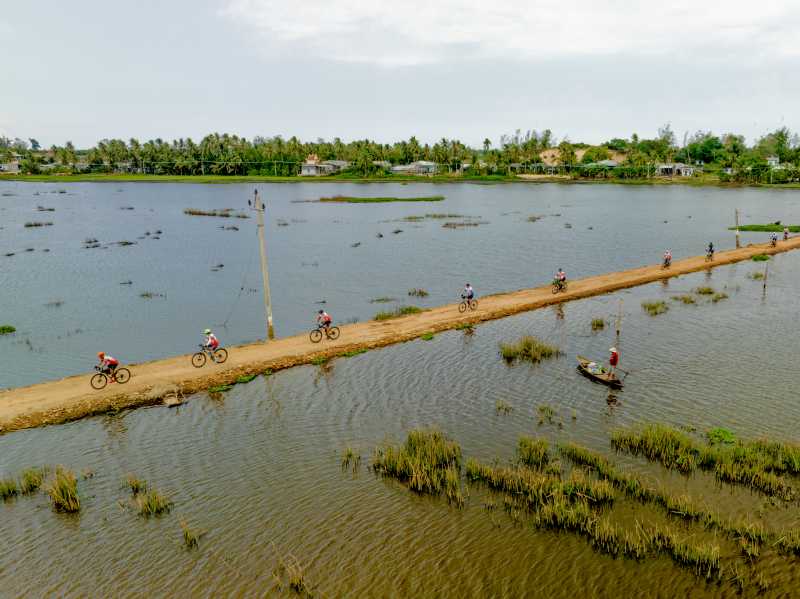 Cycling surrounded by rice paddies and village life in rural Vietnam