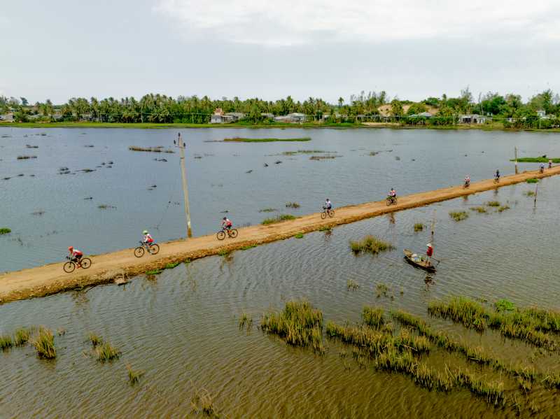 Cycling surrounded by rice paddies and village life in rural Vietnam