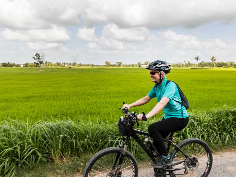 Verdant rice fields as we cycle Cambodia | Lachlan Gardiner