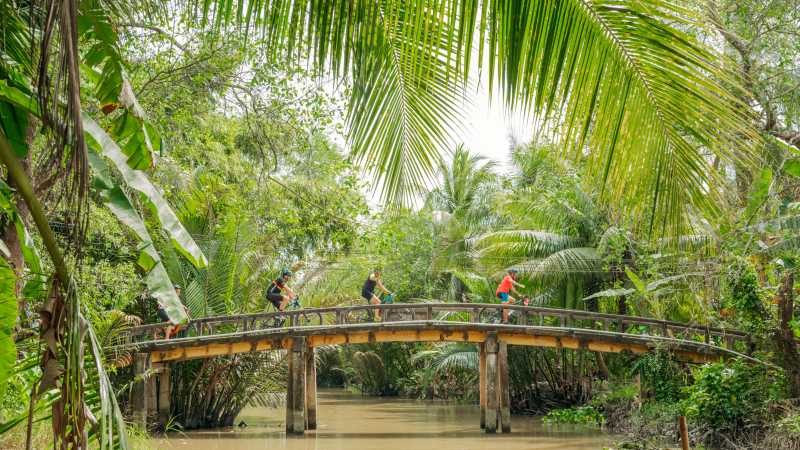 Small bridge crossing cycling through Vietnam