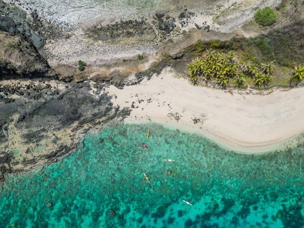 Happy kayakers enjoying paddling the remote Yasawa Islands