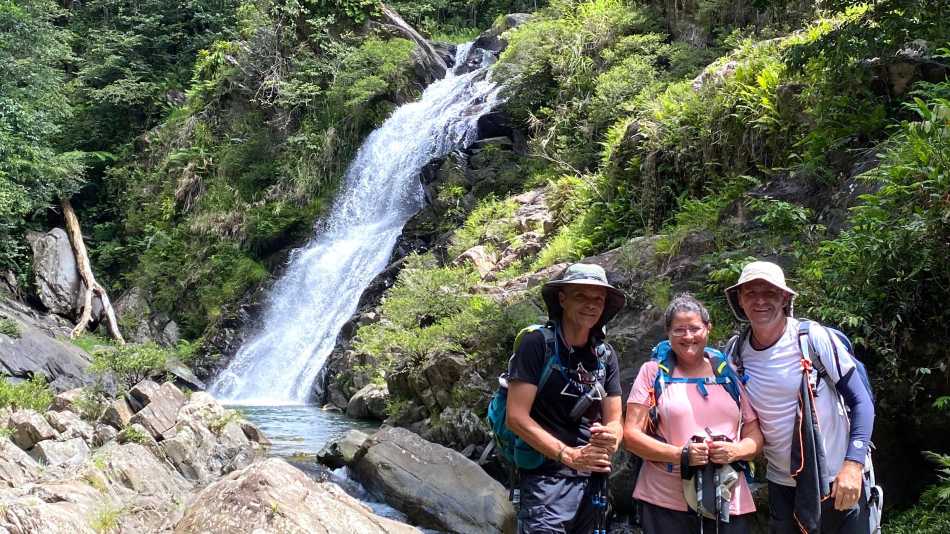 Trekkers at a waterfall rest stop along the GR Nord