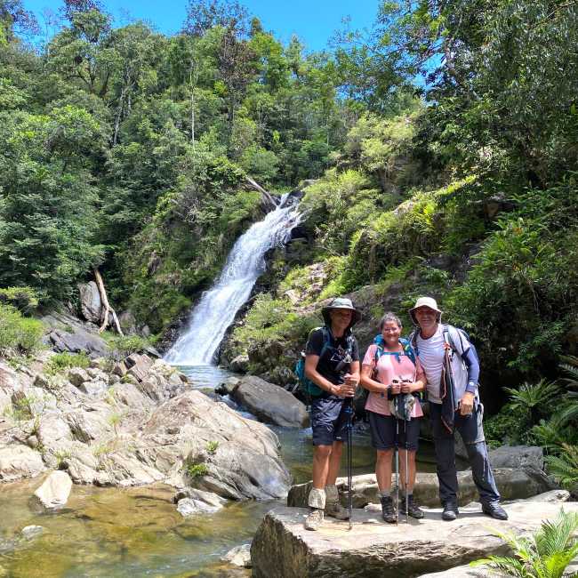 Trekkers at a waterfall rest stop along the GR Nord