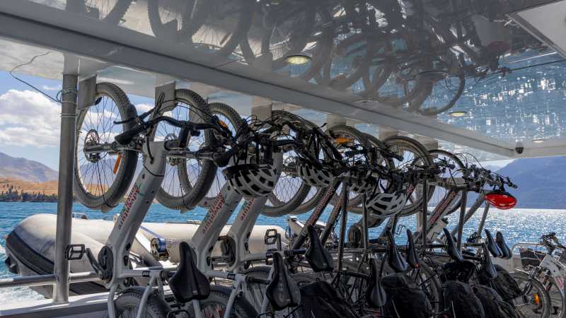 Adventure South bikes lined up in vertical racking aboard the Real NZ ferry from Walter Peak Station to Queenstown at the end of the Around the Mountains cycle trail. | Izzi Barton