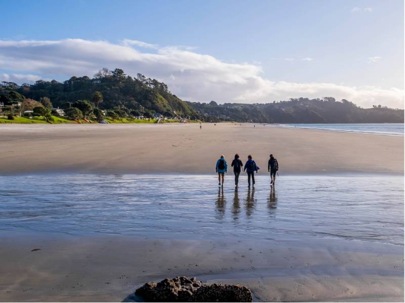 A group of walkers crossing the tidal estuary on the Te Ara Hura | Gabrielle Young