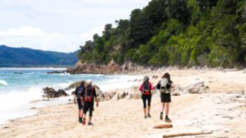 Enjoying a beach walk at Goat Bay, one of the first sections of the Abel Tasman Track