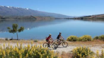 Cycling alongside Lake Dunstan