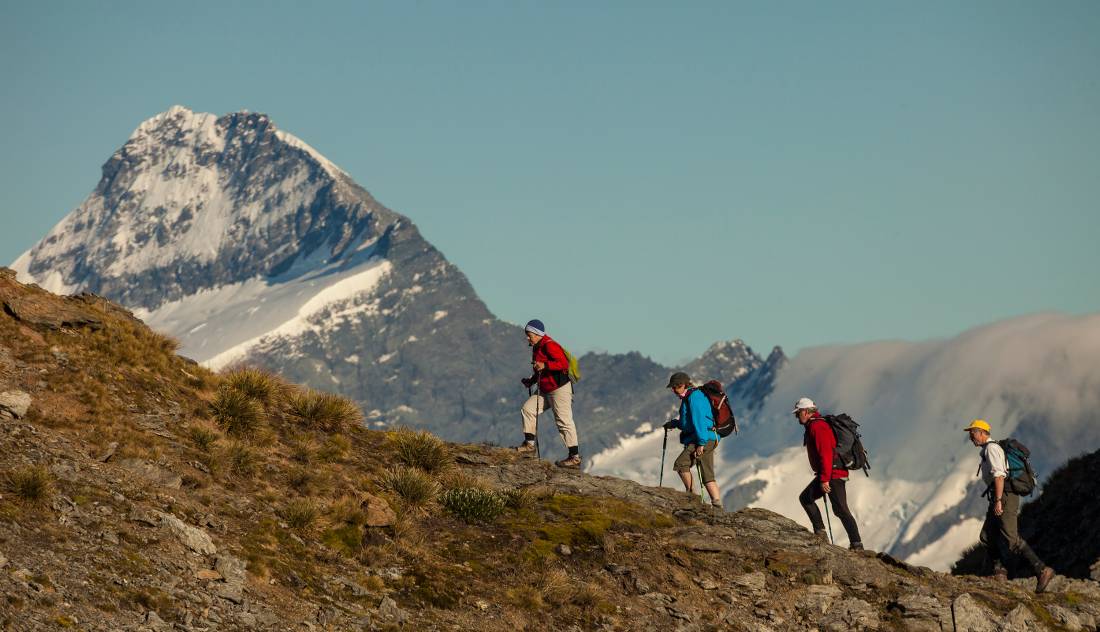 Trekkers on Buchanan peak with Mount Aspiring behind, walking above Matukituki valley, near Lake Wanaka |  <i>Colin Monteath</i>