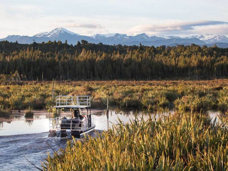 Experience the serene beauty of the Lake Mahinapua waterways on a sunset cruise | Lake Mahinapua Scenic Waterways