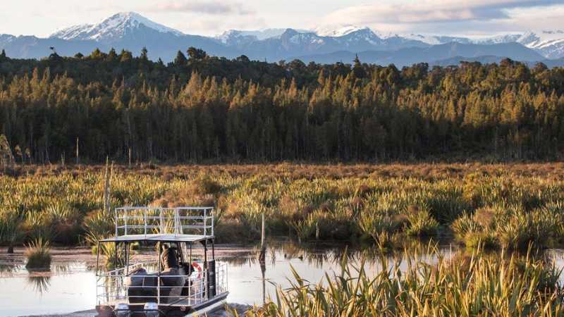 Experience the serene beauty of the Lake Mahinapua waterways on a sunset cruise | Lake Mahinapua Scenic Waterways