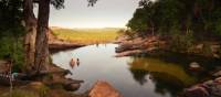 Relaxing in the waterhole above Gunlom Waterfall on the Kakadu Walking Adventure | Rhys Clarke