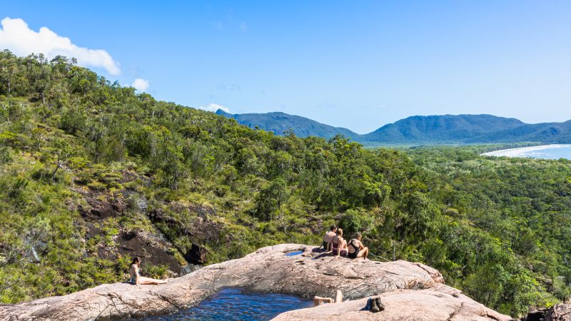Thorsborne Trail trekkers resting beside a rock pool on Hinchinbrook Island - Thorsborne Trail Guided Walk, Australia