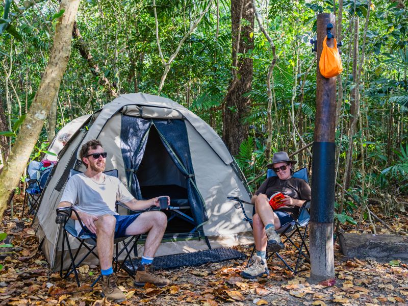 Thorsborne Trail trekkers relaxing at a rainforest campsite, Queensland | Eloise Weston