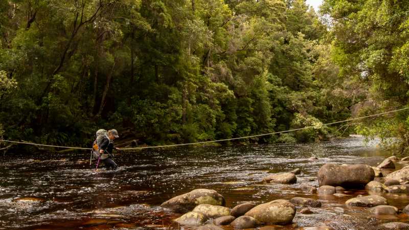 Crossing a river on the South Coast Track in Tasmania | John Dalton