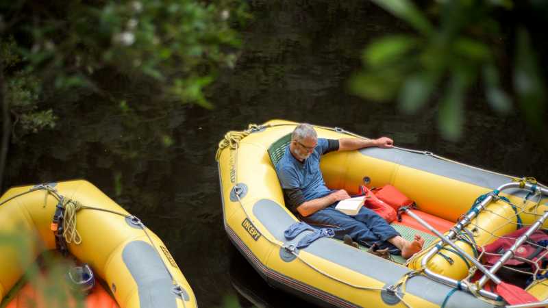 Rafter reading a book in the raft | Glenn Walker