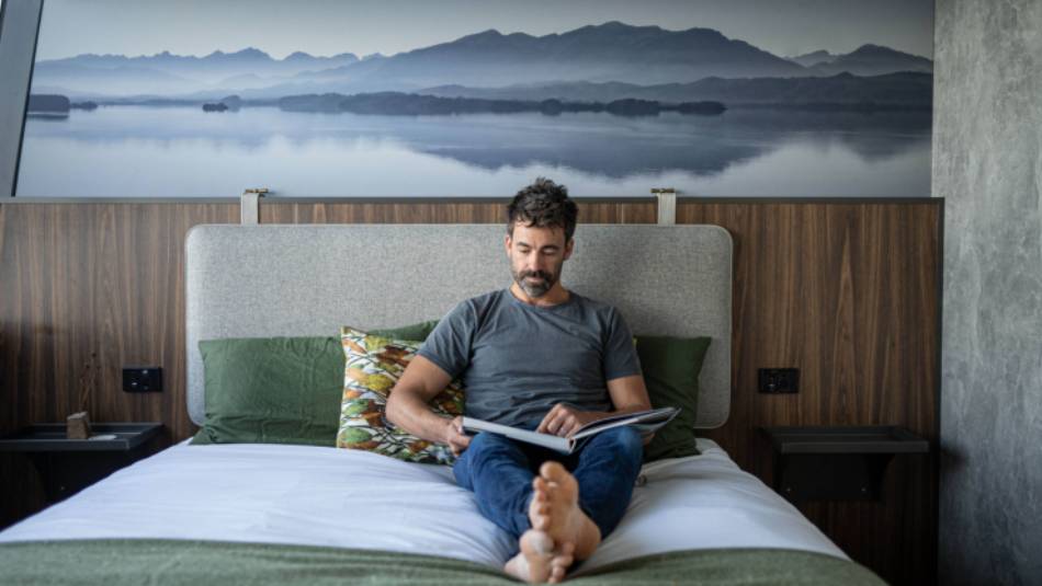 Guest relaxing in expedition vessel Odalisque's boutique cabins
