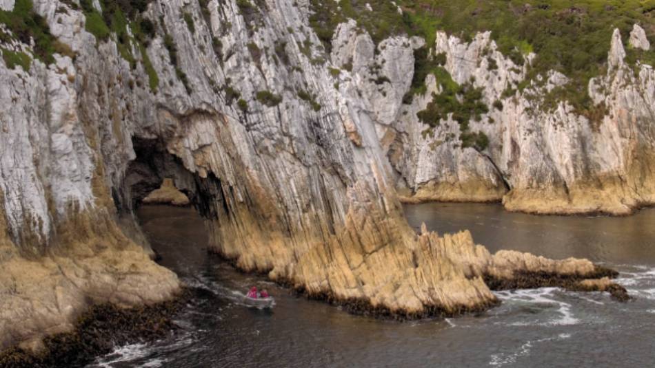 Guests pass through a seacave in tender