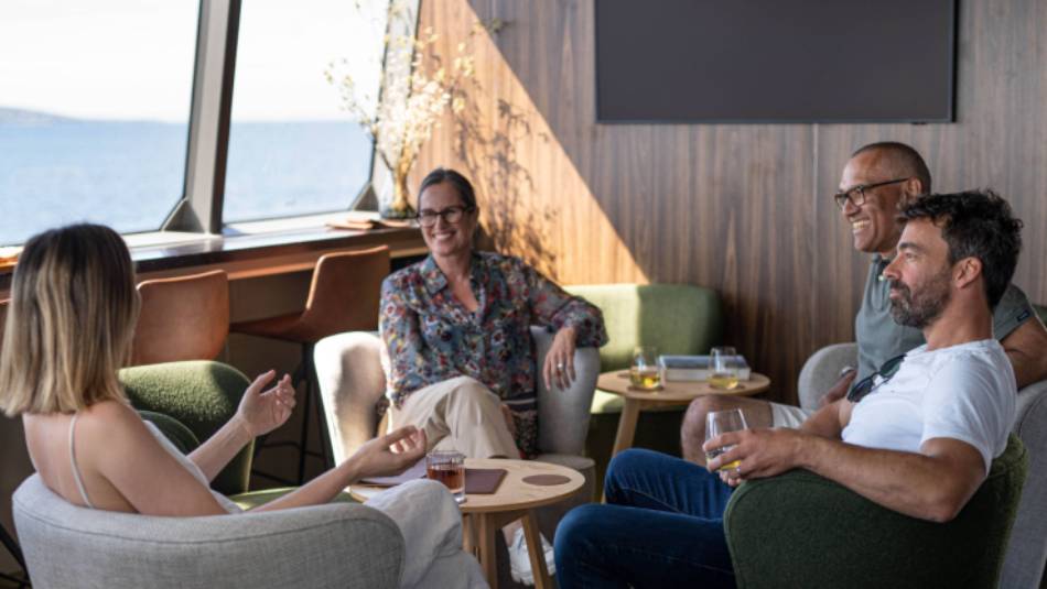 Guests relaxing in expedition vessel Odalisque's Wheelhouse Lounge & Bar