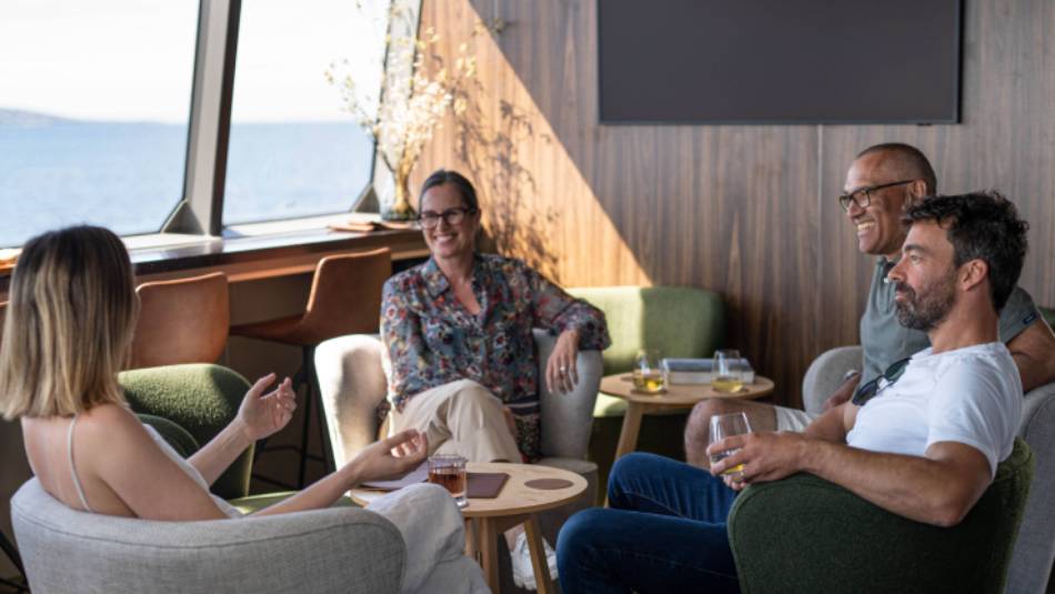 Guests relaxing in expedition vessel Odalisque's Wheelhouse Lounge & Bar