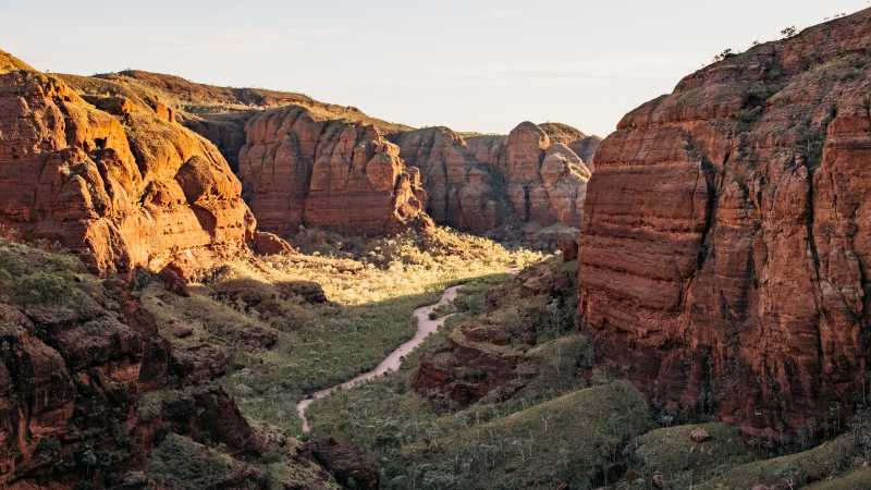 Embark on an exhilarating trek through the rugged terrain of Piccaninny Creek bed, immersing yourself in the exploration of the remote and spectacular gorge network. | Tourism Western Australia