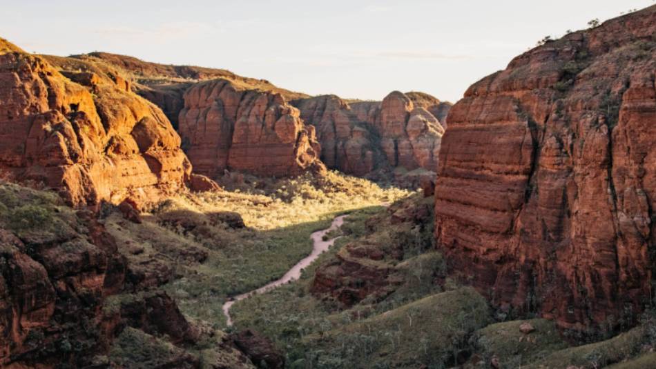 Embark on an exhilarating trek through the rugged terrain of Piccaninny Creek bed, immersing yourself in the exploration of the remote and spectacular gorge network. | Tourism Western Australia