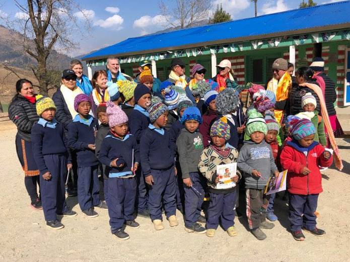 Locals welcoming the help of volunteers to build new classrooms